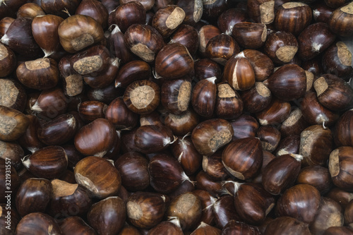 Raw chestnuts close up background. Food Background photo