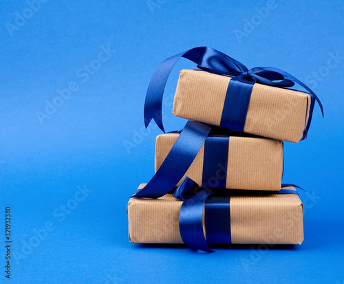 Fotografie rectangle box wrapped in brown kraft paper and tied with a silk blue ribbon