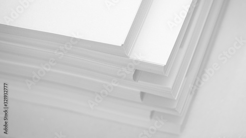 Several stacks of white paper on a white background