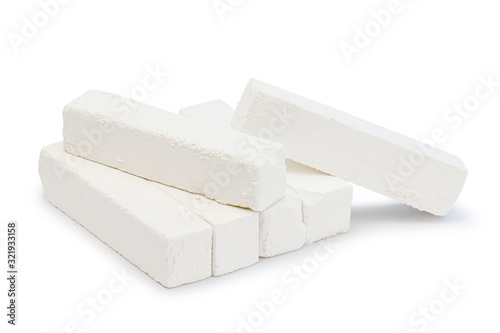 Piece of chalk isolated on white. Pure soft whitish calcite. White, sawn, natural mined chalk, environmentally friendly product. Tasty pica