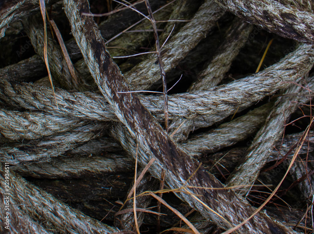 Old marine rope of gray color. Someone forgotten for a long time