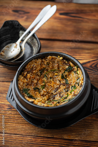 making crispy rice with korean hot stone bowl bibimbap