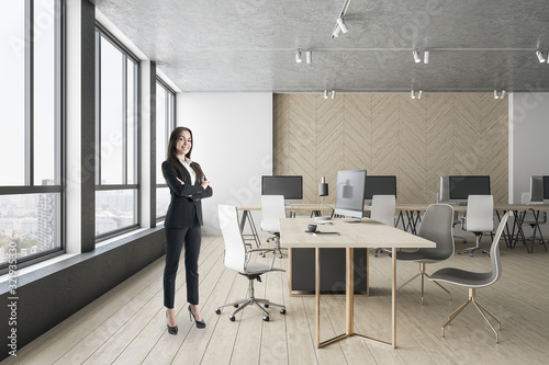 Businesswoman standing in contemporary office interior