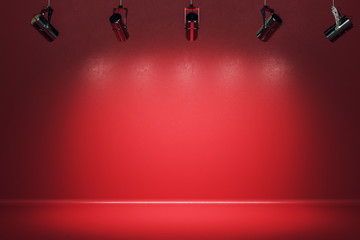 Illuminated red stage with spotlight