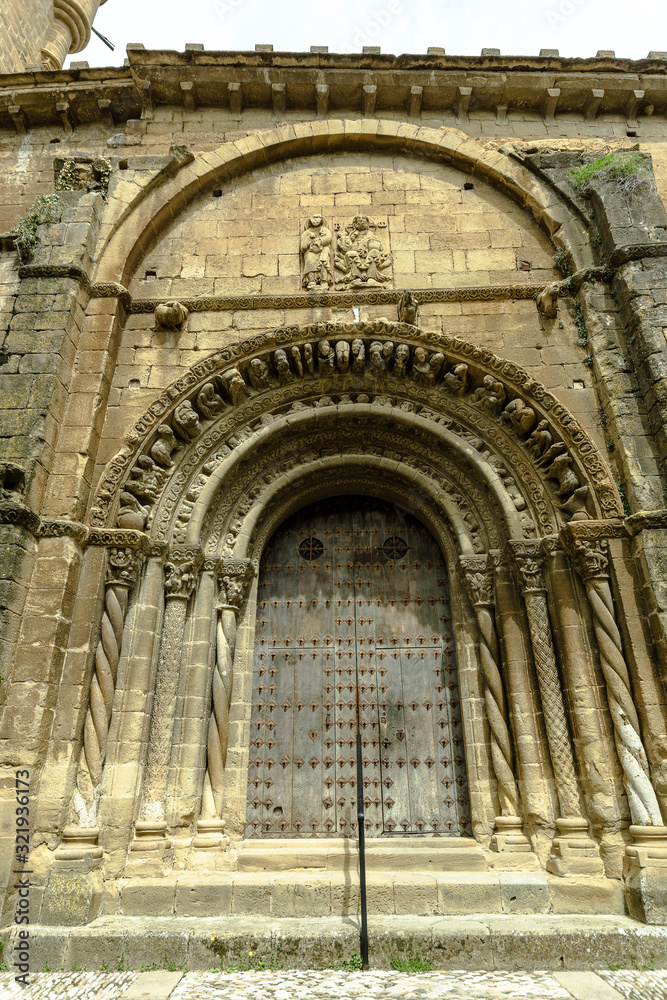 Uncastillo, Aragon, Spain April 22, 2018 Church of Santa Maria la Mayor 10th century facade and front door
