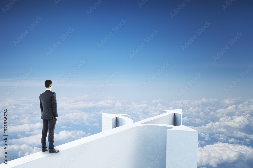 Businessman standing on abstract arrow Businessman standing on abstract arrow