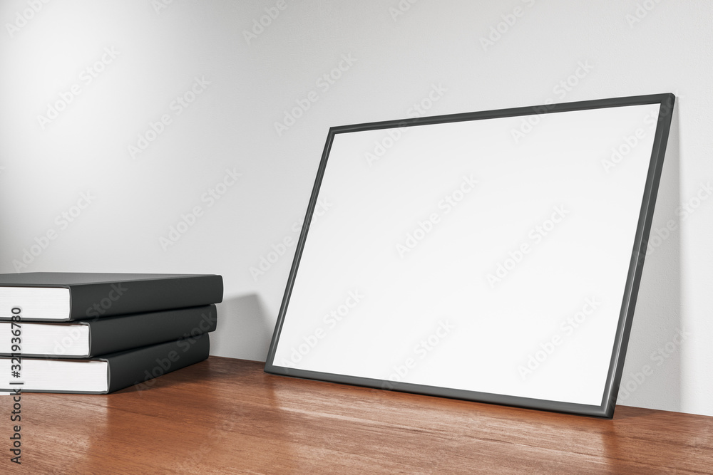 Blank poster and books standing on wooden floor Blank poster and books standing on wooden floor