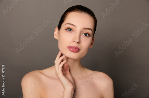 Beautiful woman face neck shoulders touches her face.