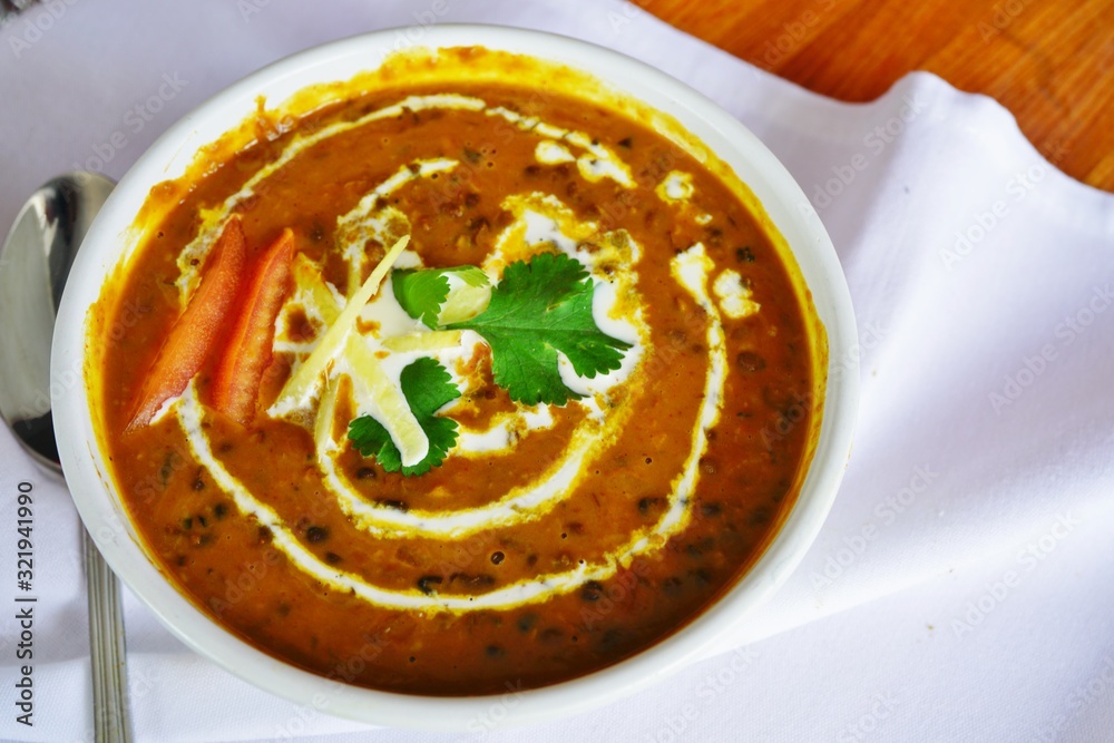 A dish of brown dal makhani lentil stew at an Indian restaurant A dish of brown dal makhani lentil stew at an Indian restaurant