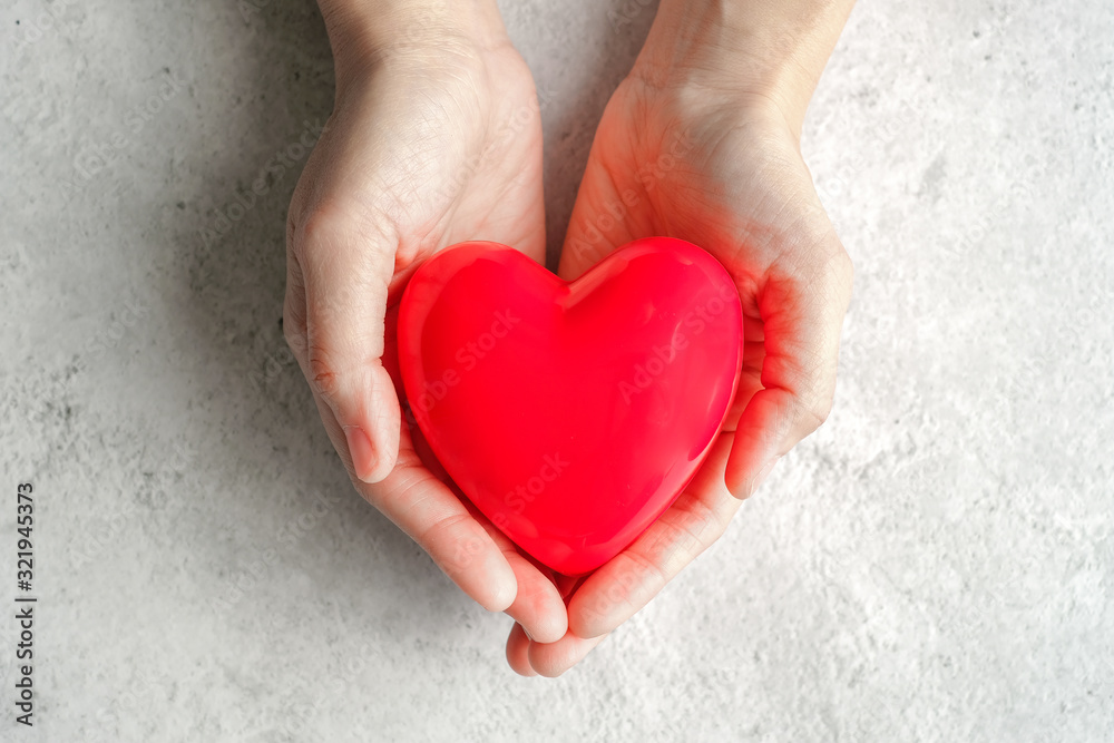 hand carrying heart .love and cardio health concept.valentine and wedding theme. hand carrying heart .love and cardio health concept.valentine and wedding theme.