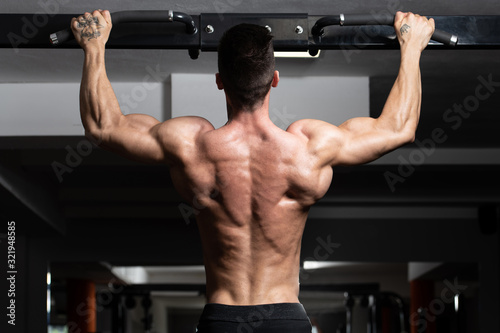 Male Athlete Doing Pull Ups © Jale Ibrak