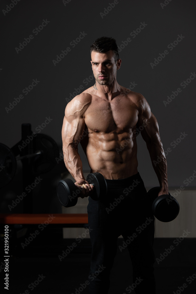 Muscular Man Exercising Biceps With Dumbbell