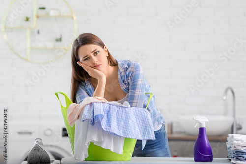 Tired housewife with laundr...