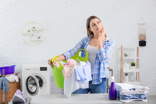 Tired housewife with laundr...