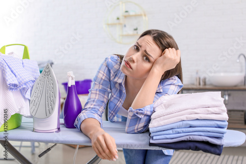 Tired housewife with laundr...