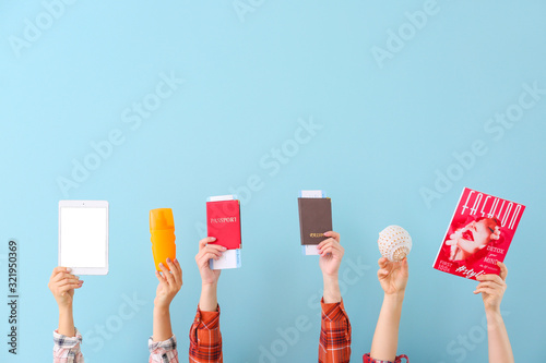Many hands with travel item...