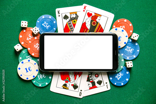 Wall Mural Chips and playing cards for gambling games with mobile phone on color background