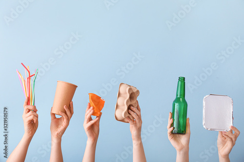 Schilderij op canvas Hands with garbage on color background. Concept of recycling