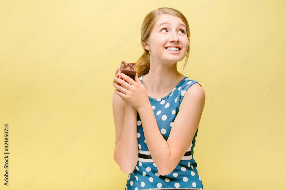 girl in dress holds a gift in hands girl in dress holds a gift in hands