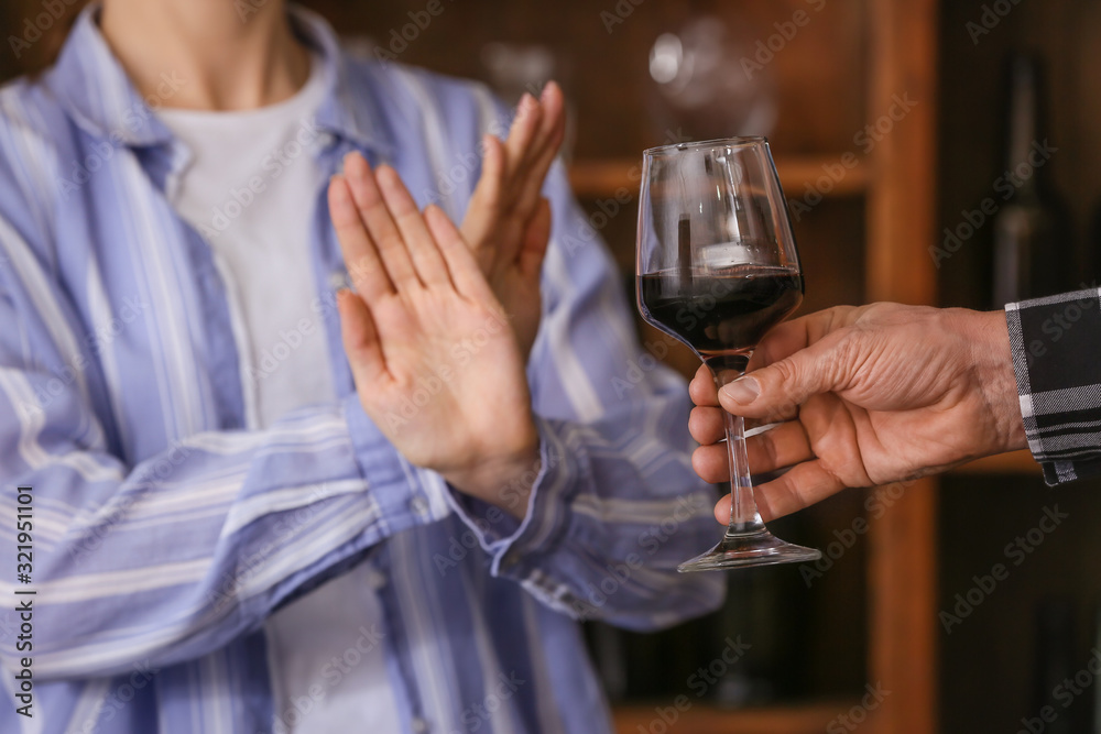 Woman refusing to drink wine in bar. Concept of alcoholism Woman refusing to drink wine in bar. Concept of alcoholism