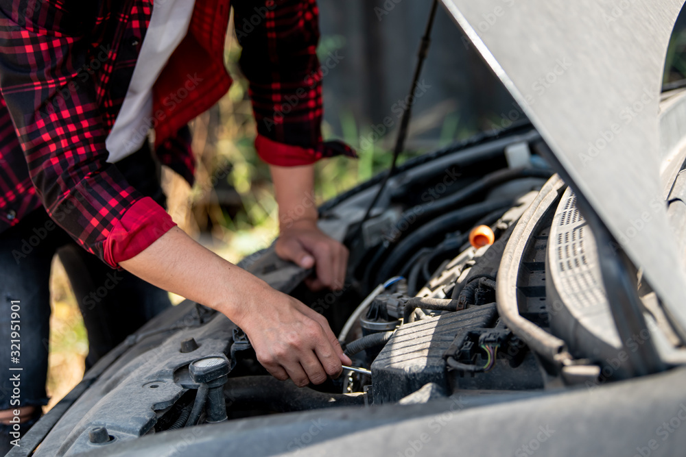 The auto mechanic is checking the car for maintenance,select focus. The auto mechanic is checking the car for maintenance,select focus.