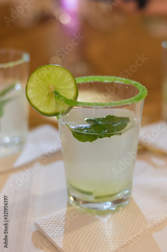 The glass with lemonade, lemon and mint