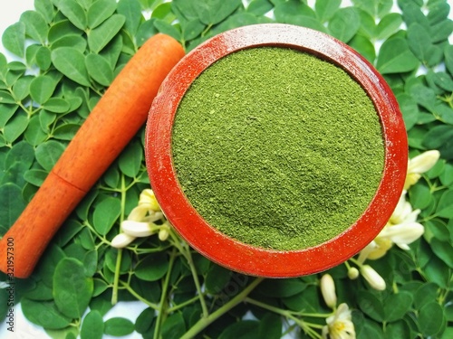 Moringa leaves and flowers (Moringa oleifera) Moringa powder capsules Isolated on a white background Moringa powder for making tea(herbs)