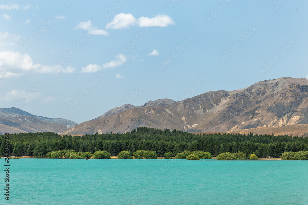 Blue water lake landscape with mountains and clear sky, Lake Tekapo, New Zealand Blue water lake landscape with mountains and clear sky, Lake Tekapo, New Zealand