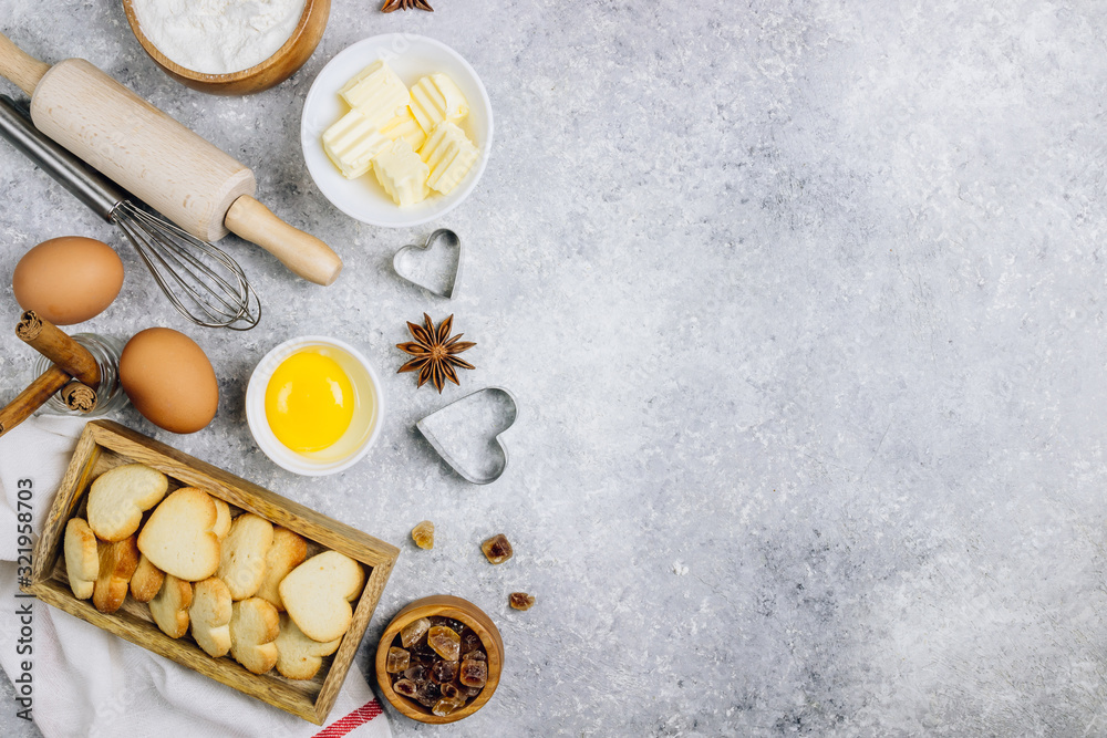 Valentine's Day baking culinary background. Ingredients for cooking on wooden kitchen table, baking recipe for pastry. Heart shape cookies. Top view. Flat lay. Valentine's Day baking culinary background. Ingredients for cooking on wooden kitchen table, baking recipe for pastry. Heart shape cookies. Top view. Flat lay.