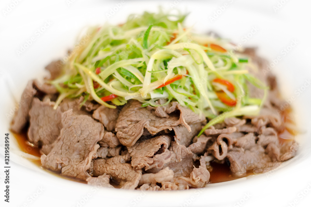 Chinese style fried beef topped with green fresh vegetable Chinese style fried beef topped with green fresh vegetable