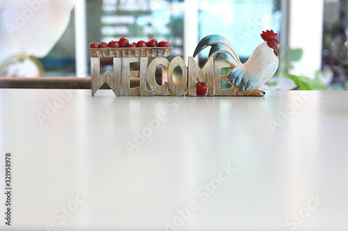 sign board carving from wooden with welcome word and chicke use for decoration photo