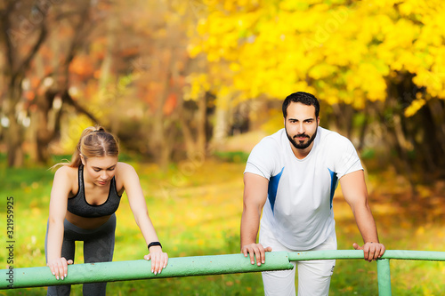 Woman training with personal trainer at park