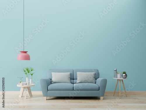 Modern living room interior with sofa and green plants,lamp,table on blue wall background.