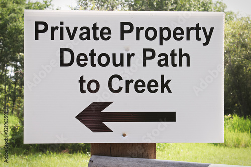 A private property detour path to creek sign