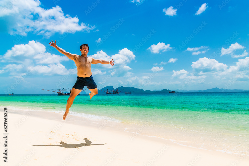 Nature for life Happy summer lifestyle young Asian traveler jump on sunny vacation beach, Active tourist male joy travel Phuket Trang Thailand fun beach, Tourism beautiful destination Asia