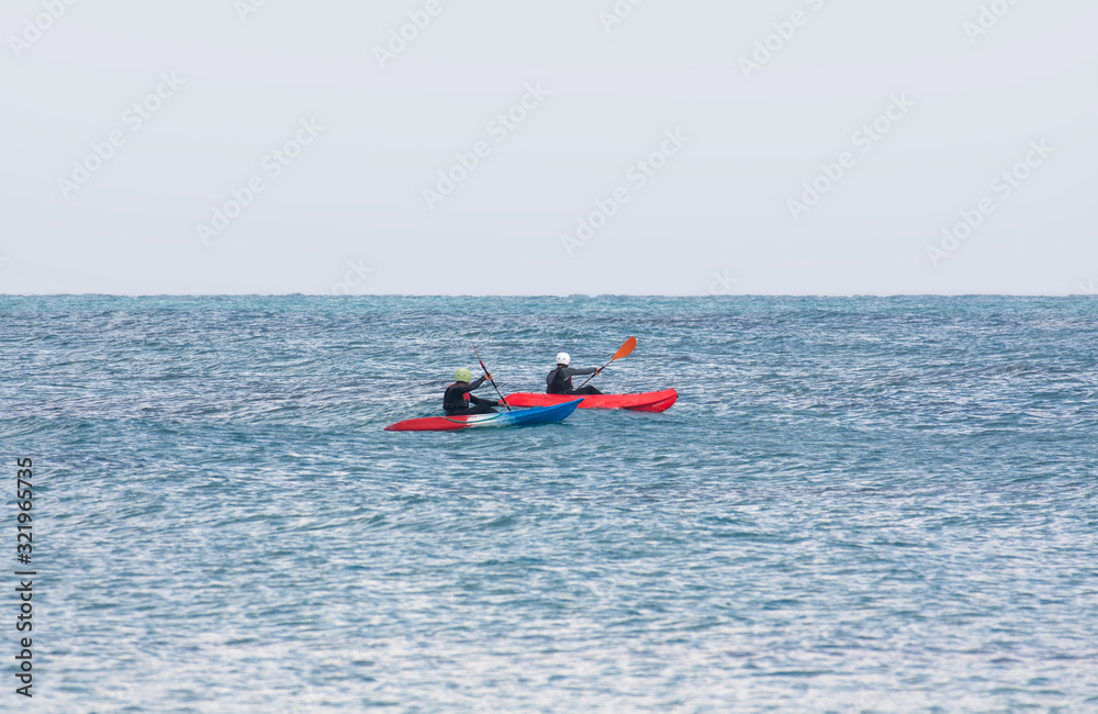 A pair of kayakers in the sea as an emphasis point