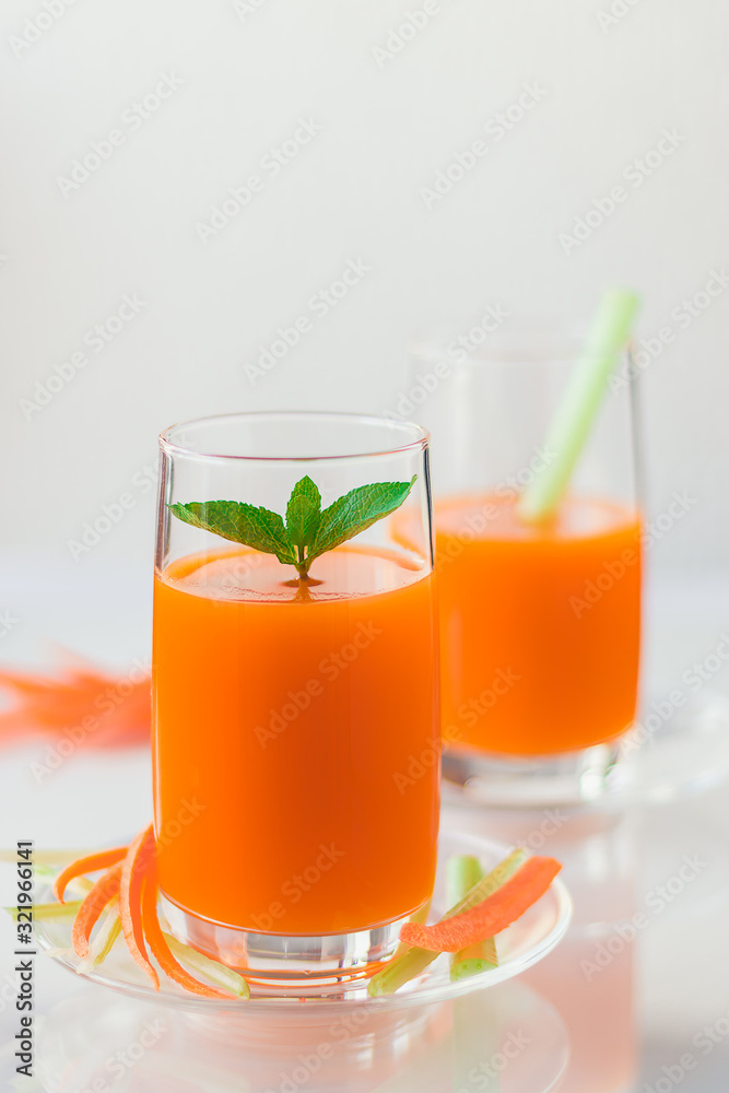 Freshly squeezed carrot juice with celery, vertical orientation Freshly squeezed carrot juice with celery, vertical orientation