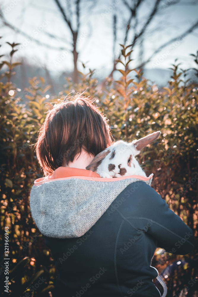 Beautiful girl with rabbit on a sunny day in the garden Beautiful girl with rabbit on a sunny day in the garden