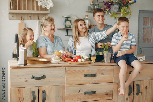 Family in a kitchen. Grandmother with grandchildren. People with vegetables