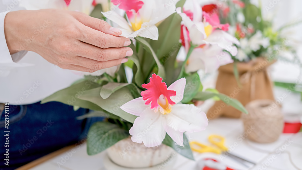 Flower shop staff arrange flowers as ordered for valentines. Flower shop staff arrange flowers as ordered for valentines.