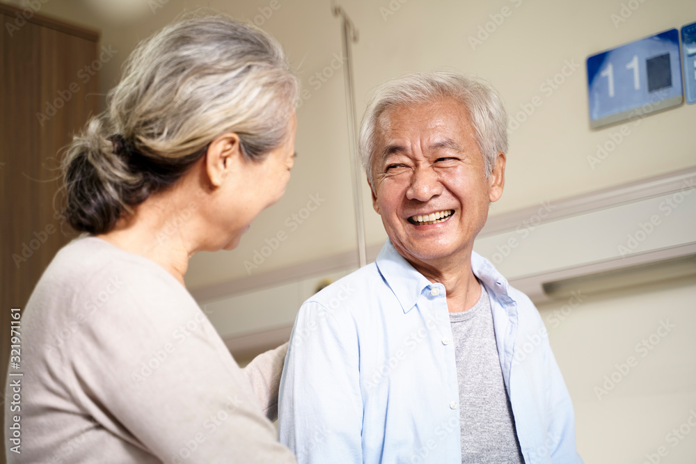 happy asian old couple chatting in hospital ward happy asian old couple chatting in hospital ward