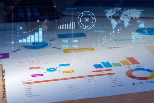 Business plan with financial graph and future growth glowing diagram and laptop at background