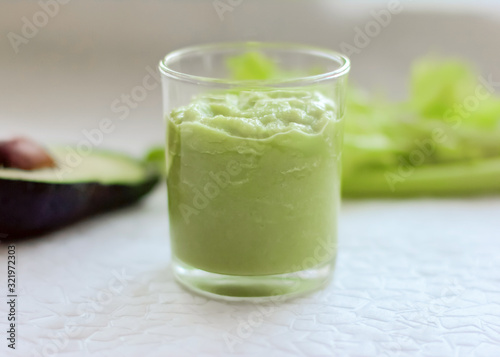 avocado and celery smoothie. weight loss and healthy food concept. vegetarian meal plan. greens in the kitchen. blended green smoothie.