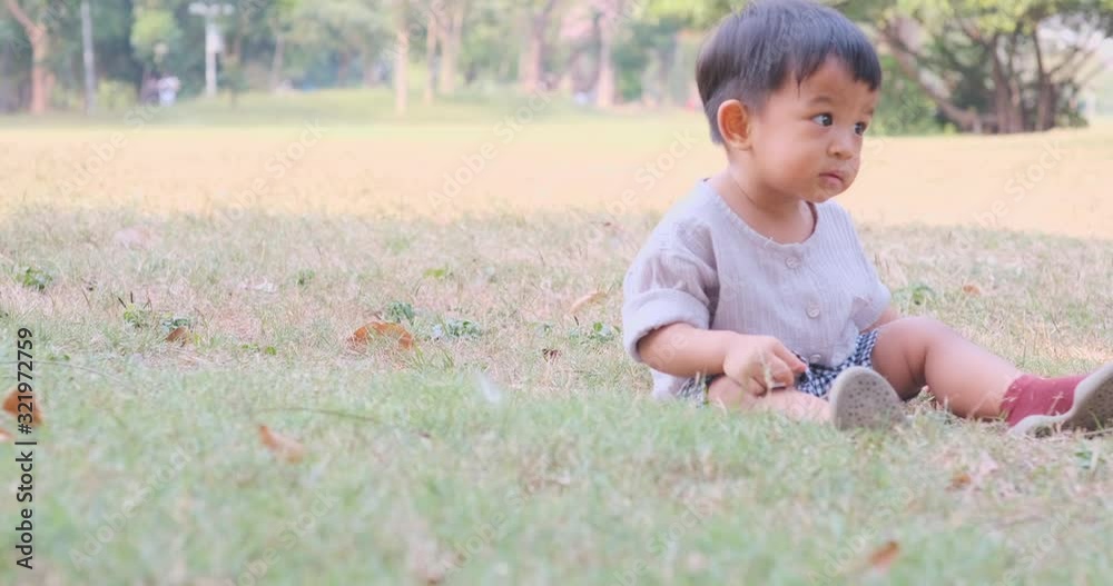 Asian baby toddler boy playing in city public park nature learnning activity 1-2 year old boy Asian baby toddler boy playing in city public park nature learnning activity 1-2 year old boy