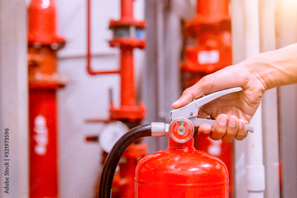 Close up Fire extinguisher and pulling pin on red tank.