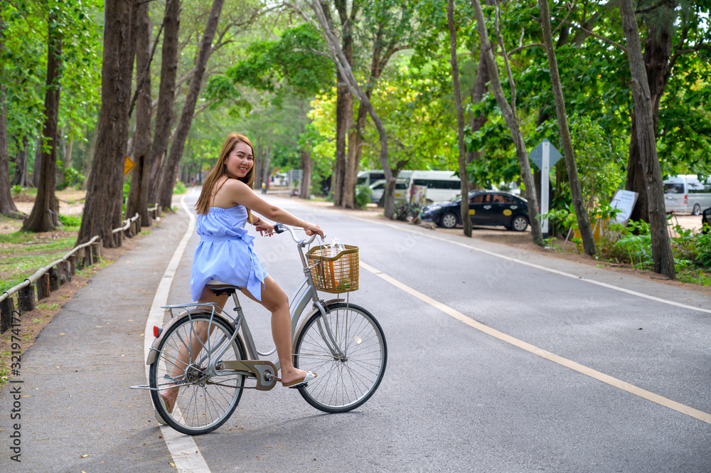 young woman riding a bicycle in the park