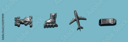 Banner 4 metal action figures toys types of transport: car racing car, roller skates, airplane, skateboard. A false transport. Flatlay, top view, layout