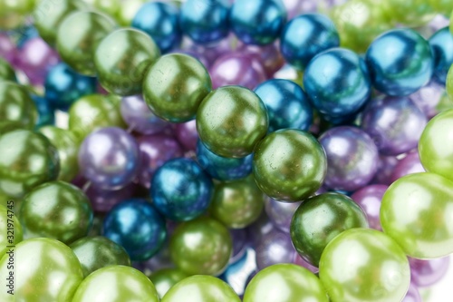 colored pearls close-up. pearl beads round background.blue, purple, green and pink beads texture.Beautiful decoration background 