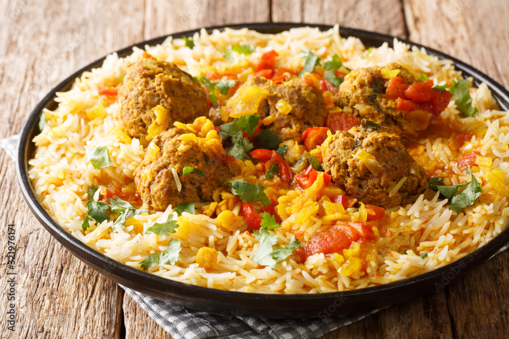 Kofta Chalao Stewed meat balls in spicy sauce with yellow peas served with basmati rice close-up in a plate. horizontal Kofta Chalao Stewed meat balls in spicy sauce with yellow peas served with basmati rice close-up in a plate. horizontal