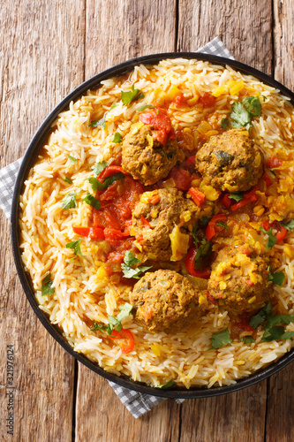 Kofta challow is a traditional Afghan dish consisting of meatballs and white rice close-up in a plate. Vertical top view